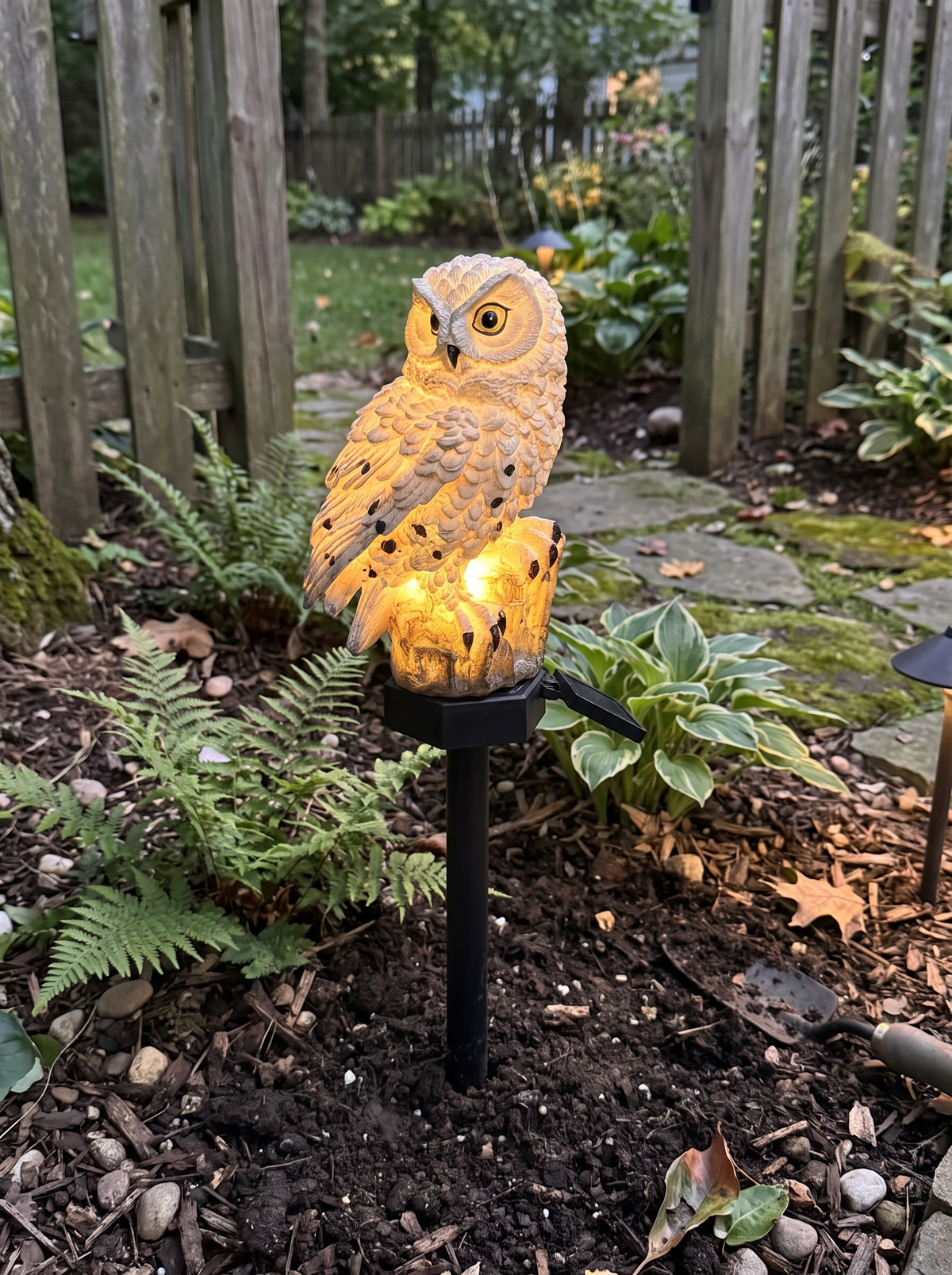 Solar Owl Garden Light staked into a garden bed